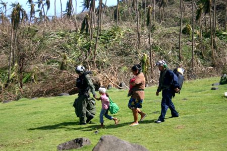 US Navy 090917-N-xxxxx-002 A pilot assigned to Helicopter Sea Combat Squadron (HSC) 25 escorts a mother and her two children to an MH-60S Sea Hawk helicopter