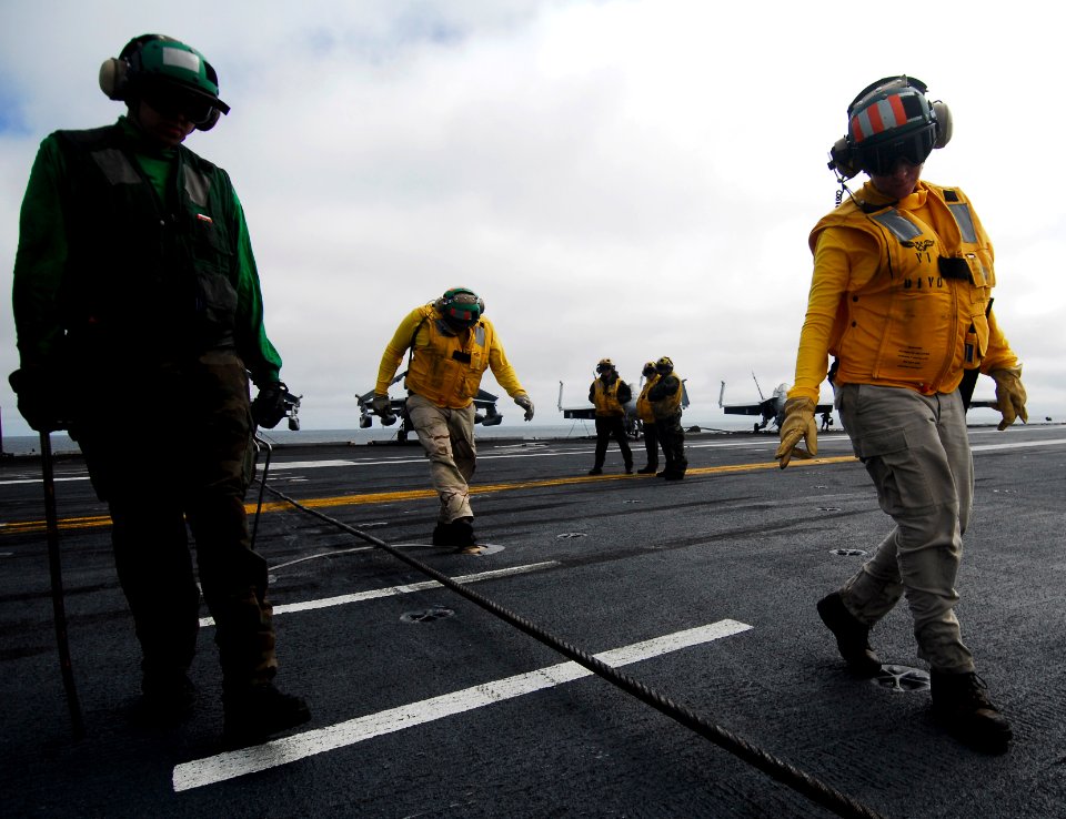 US Navy 090919-N-6538W-034 Lt. Jessica Parker, from St. Louis, Mo., and Aviation Boatswain's Mate (Equipment) Airman Recruit Kevin Starr, from Fayetteville, Ark., inspect the integrity of a cross-deck pendant