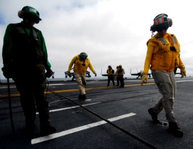 US Navy 090919-N-6538W-034 Lt. Jessica Parker, from St. Louis, Mo., and Aviation Boatswain's Mate (Equipment) Airman Recruit Kevin Starr, from Fayetteville, Ark., inspect the integrity of a cross-deck pendant