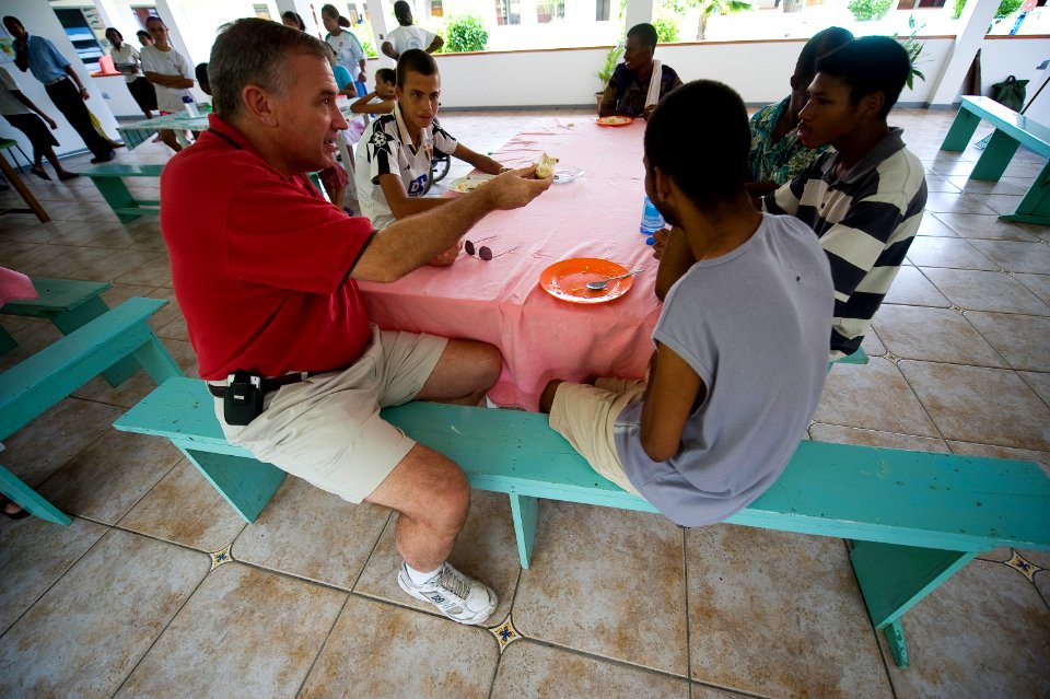 US Navy 090921-N-4154B-059 Rear Adm. (lower half) Scott E. Sanders, commander of Combined Task Force (CTF) 151, visits and shares some fresh cut sugar cane with young patients at a local rehabilitation clinic in the Republic of