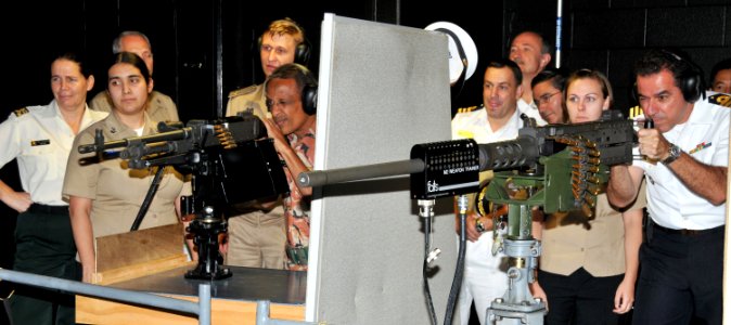 US Navy 090925-N-8848T-931 Foreign Naval attaches fire 50-caliber and M-240 machine gun simulators in the Center for Surface Combat Systems unit at Training Support Center