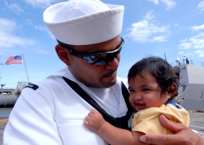 US Navy 090921-N-2456S-100 Sonar Technician (Surface) 3rd Class Frank Diaz assigned to the guided-missile destroyer USS Bainbridge (DDG 96) holds his four-month old son for the first time following his return home to Naval Stat