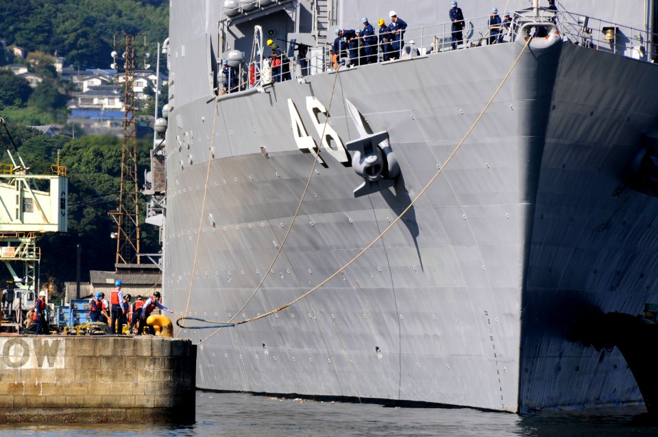 US Navy 090924-N-8335D-155 Line-handlers cast off the dock landing ship USS Tortuga (LSD 46) as she departs Sasebo