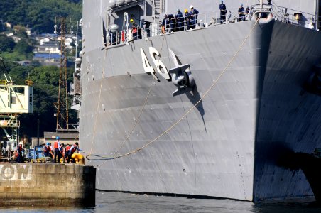 US Navy 090924-N-8335D-155 Line-handlers cast off the dock landing ship USS Tortuga (LSD 46) as she departs Sasebo photo