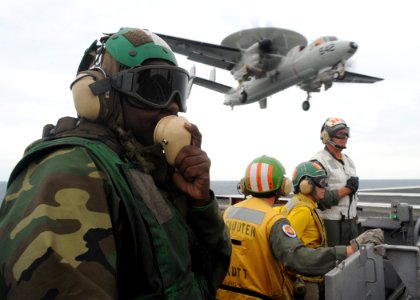 US Navy 090925-N-9988F-012 Aviation Boatswain's Mate (Equipment) 3rd Class Quasi Alexander communicates through sound-powered phones during flight operations aboard the aircraft carrier USS Dwight D. Eisenhower (CVN 69)