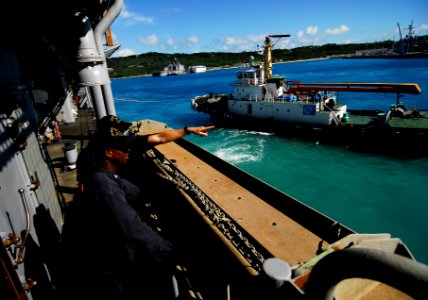 US Navy 090928-N-0807W-048 Tug boats guide the amphibious dock landing ship USS Harpers Ferry (LSD 49) from White Beach Naval Facility, Okinawa, Japan