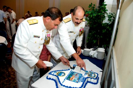 US Navy 090924-N-2728S-116 Rear Adm. William G. Sizemore II, arriving Chief of Naval Air Training, left, and Rear Adm. Mark D. Guadagnini, departing Chief of Naval Air Training, take part in the traditional cake cutting