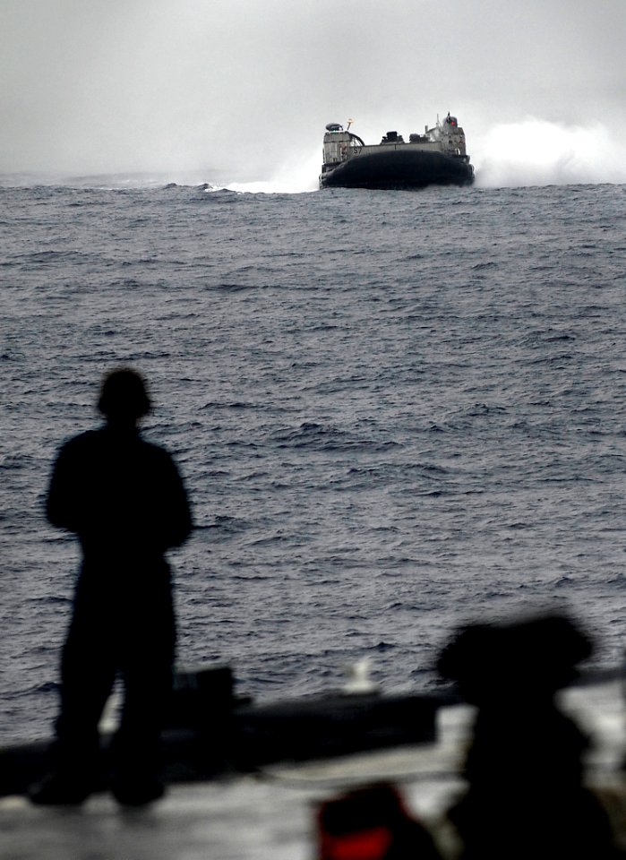 US Navy 090928-N-0807W-110 Landing Craft Air Cushion 57, assigned to Assault Craft Unit 5, prepares to enter the well deck of the amphibious dock landing ship USS Harpers Ferry (LSD 49)