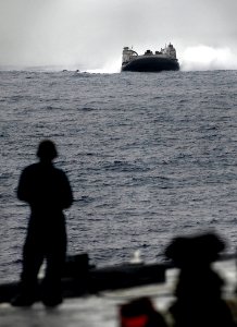 US Navy 090928-N-0807W-110 Landing Craft Air Cushion 57, assigned to Assault Craft Unit 5, prepares to enter the well deck of the amphibious dock landing ship USS Harpers Ferry (LSD 49) photo