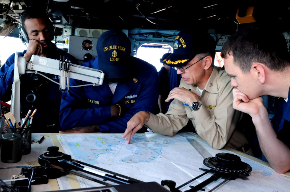 US Navy 090926-N-7478G-091 Capt. Thom W. Burke, commanding officer of the amphibious command ship USS Blue Ridge (LCC 19), looks over a chart as Blue Ridge prepares to go underway after a port visit to Noumea, New Caledonia