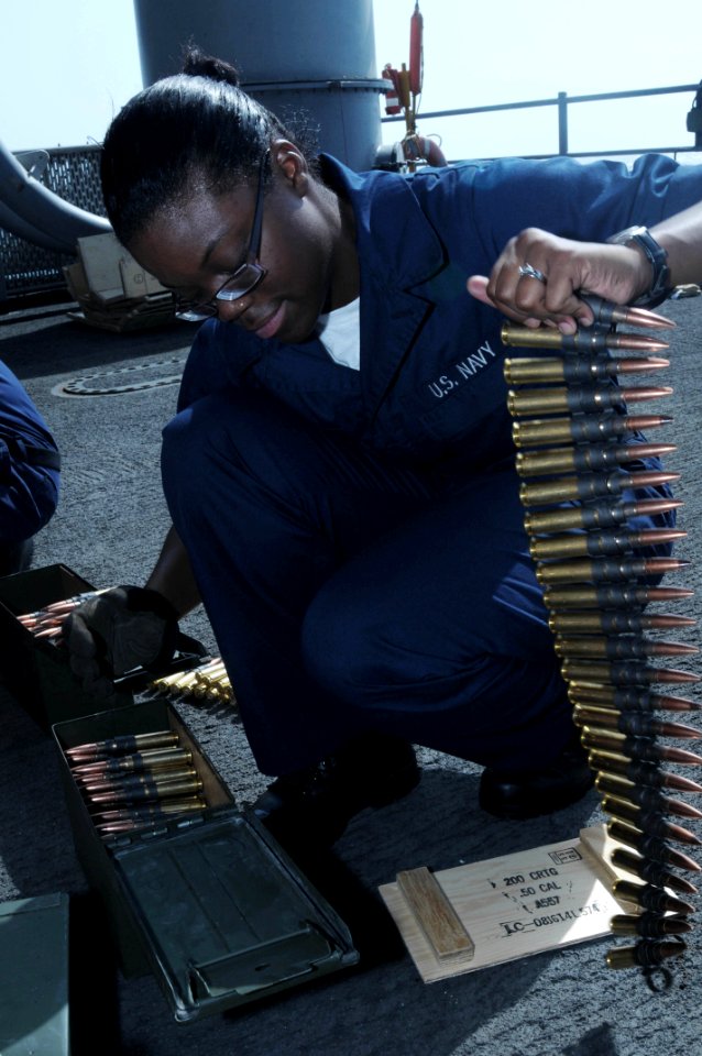 US Navy 090925-N-3038W-126 Aviation Ordnanceman Airman Recruit Janelle Ray prepares .50 cal. ammunition belts before a live-fire exercise aboard the aircraft carrier USS Nimitz (CVN 68)