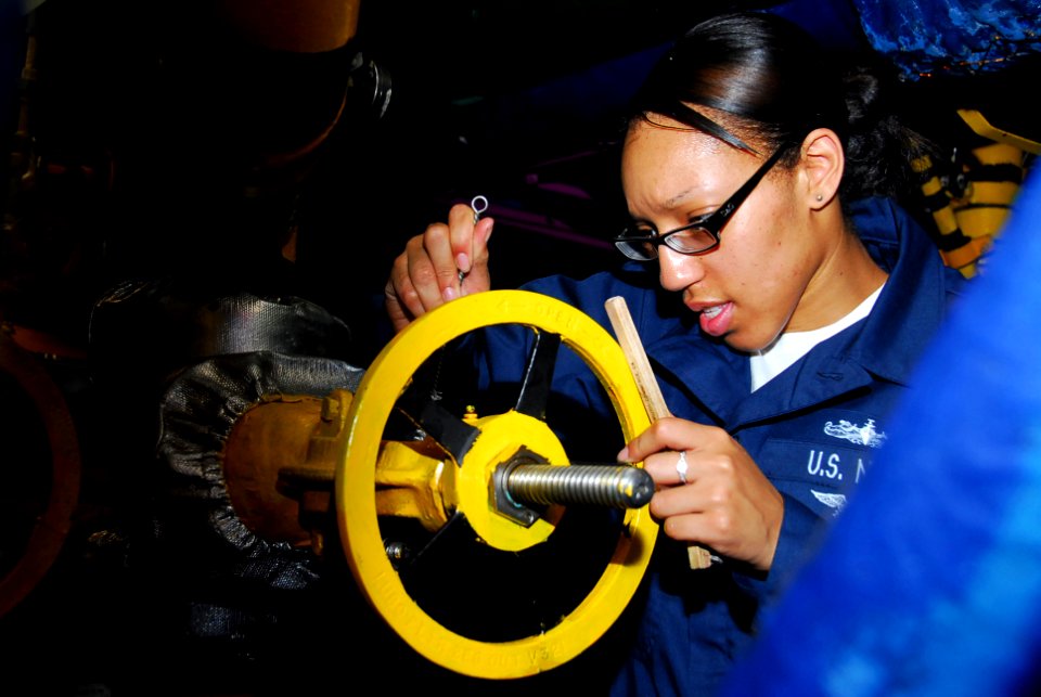 US Navy 090927-N-2918M-023 Machinist Mate Fireman Candilyn Elam does maintenance on a pressure valve in the forward diesel room aboard the aircraft carrier USS Nimitz (CVN 68)