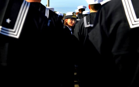 US Navy 090925-N-5345W-019 Operations Officer Lt. Rose Goscinski looks over Sailors uniforms during an all hands uniform inspection aboard the amphibious dock landing ship USS Fort McHenry (LSD 43) during a port visit to Salala