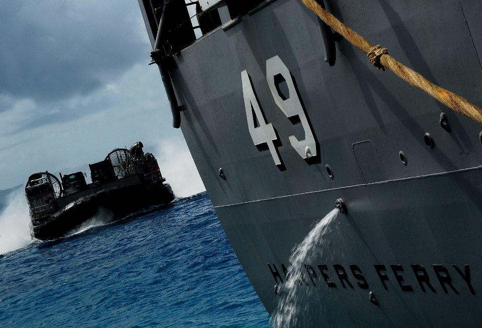 US Navy 090925-N-0807W-200 Landing Craft Air Cushioned (LCAC) 58, assigned to Assault Craft Unit (ACU) 5, brings elements of the 31st Marine Expeditionary Unit (31st MEU) and their equipment aboard