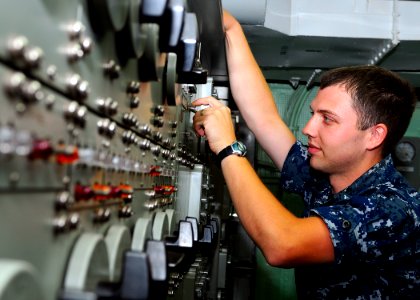 US Navy 090928-N-8132M-023 lectronics Technician 3rd Class Matthew Hanneman, from New London, Wis., monitors the voltage