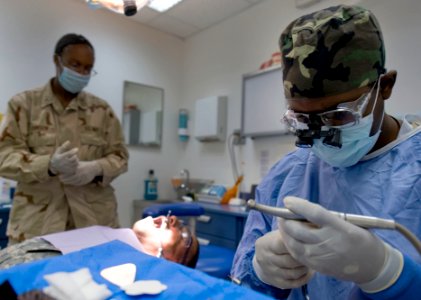 US Navy 090928-N-7526R-249 Lt. Cmdr. Rodney Scott prepares a amalgam filling
