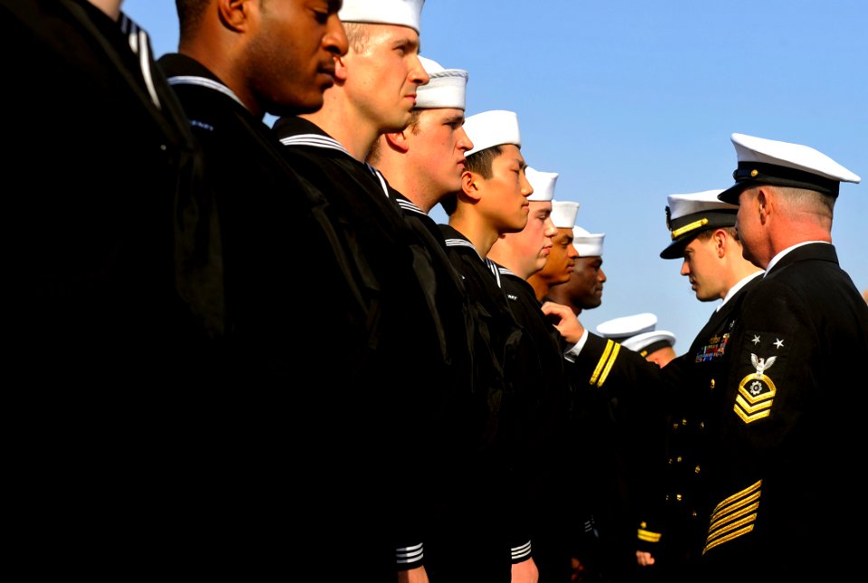 US Navy 090925-N-5345W-012 Lt. Christopher Barnes, center, chief engineer, and Master Chief Engineman Billy Strong, engineering department leading chief petty officer, conduct a uniform inspection aboard the amphibious dock lan