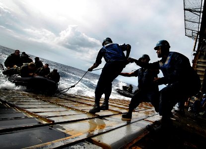 US Navy 090929-N-0807W-280 Sailors assigned to the amphibious dock landing ship USS Harpers Ferry (LSD 49) embark Marines from 31st Marine Expeditionary Unit (31st MEU) during combat rubber raid craft exercises photo