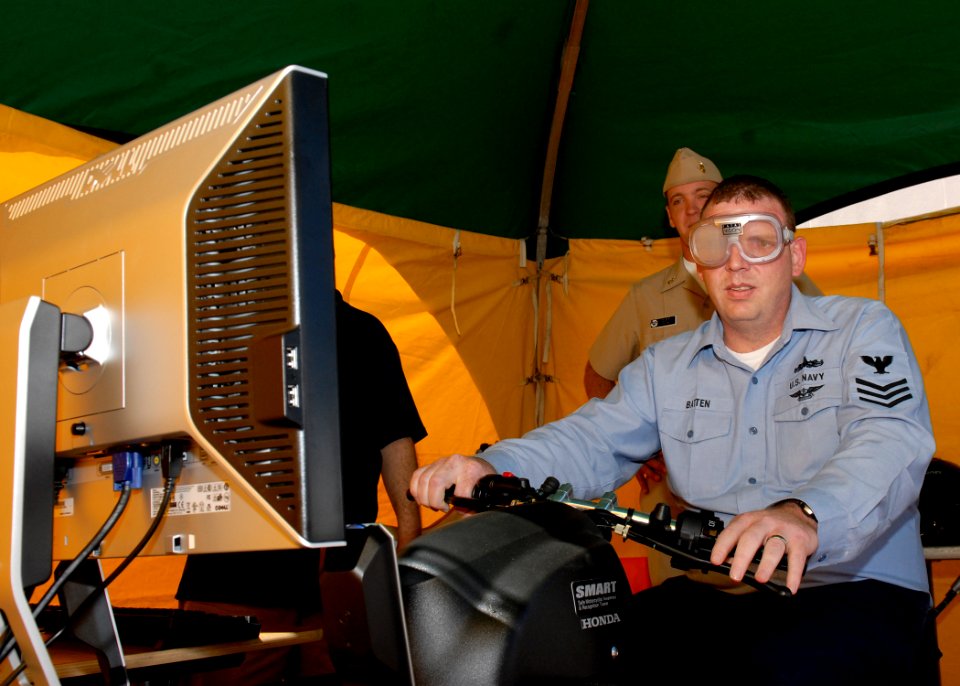 US Navy 090925-N-9520G-044 Culinary Specialist 1st Class Ken Batten, from Chesterfield, Va., operates a motorcycle simulator using training goggles designed to mimic what an alcohol-impaired driver would see