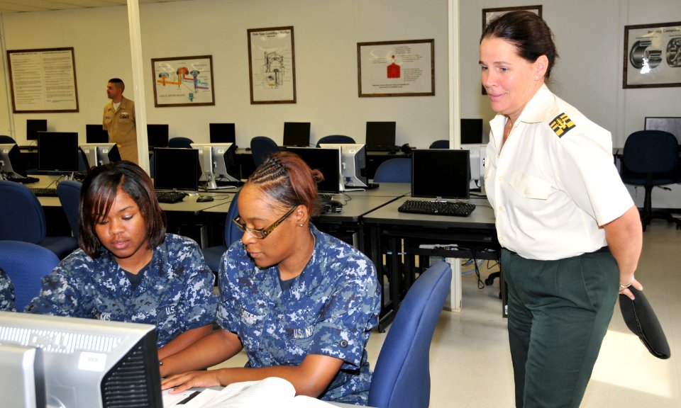 US Navy 090925-N-8848T-875 Lt. Col. Martine Dierckx, from the Belgian Armed Forces, looks over the shoulders of Fireman Brittany Trotter and Fireman Whitney Adams, both from Atlanta, in the Center for Naval Engineering Learning