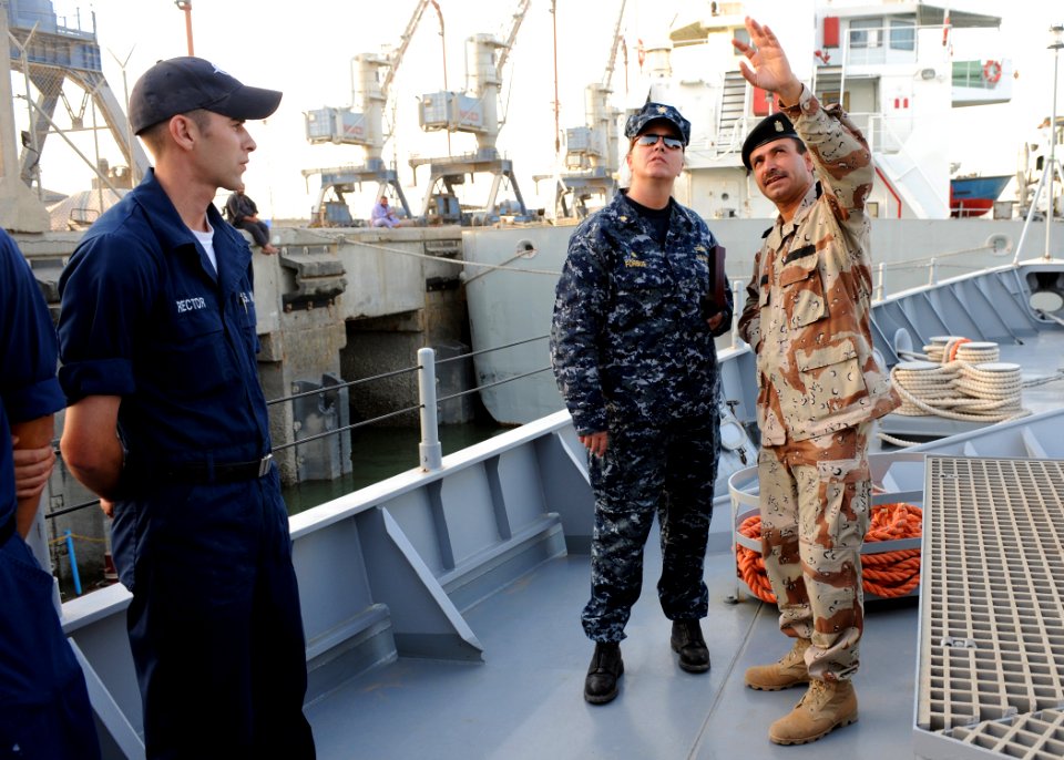 US Navy 090929-N-7088A-216 Lt. Cmdr. Jennifer Forbus, commanding officer of the mine countermeasures ship USS Dextrous (MCM 13) and her crew, tour the Iraqi ship the Fateh with Iraqi navy Capt. Ali Meta'ab Glass in Umm Qasr, Ir