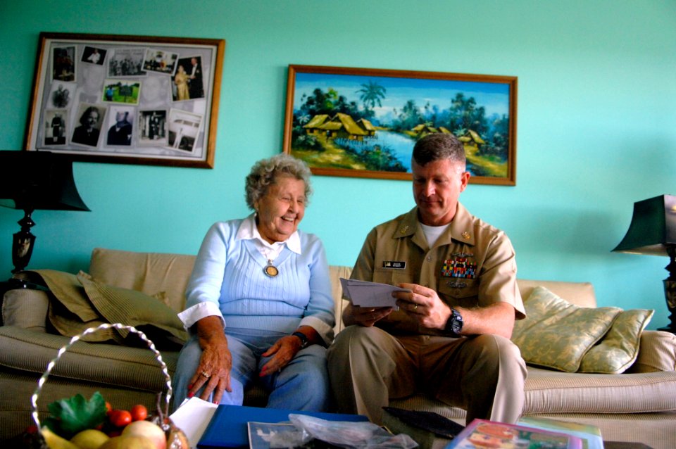 US Navy 090928-N-9818V-070 Master Chief Petty Officer of the Navy (MCPON) Rick West and Ima Black, widow of the Navy's first MCPON, Master Chief Gunner's Mate Del Black, look through old photos of Black during their visit