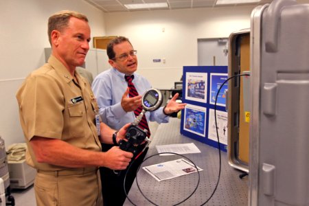 US Navy 090929-N-8863V-016 Rear Adm. Kevin Quinn, commander, Naval Surface Force Atlantic, left, operates a portable pressure calibrator as Quality Manager Jeff Walden explains its use