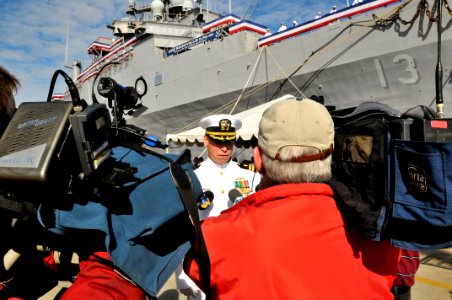 US Navy 090930-N-3595W-023 Cmdr. Brian Peterson, officer-in-charge of the amphibious transport dock ship USS Nashville (LPD 13), answers questions about the ship for local media before the ship's decommissioning ceremony