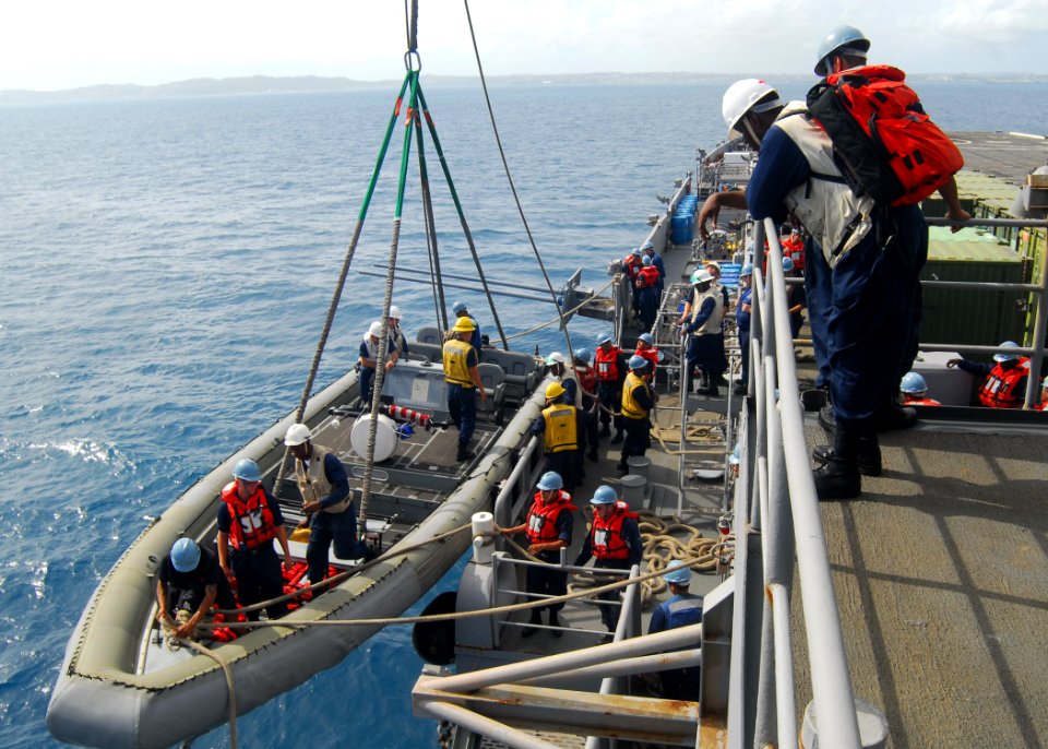 US Navy 090930-N-5538K-077 Hospital Corpsman 2nd Class Alvin R. Cotson watches over a crew preparing to launch a rigid hull inflatable boat off the starboard side of the forward-deployed amphibious transport dock USS Denver (LP