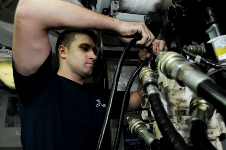 US Navy 090930-N-3038W-030 Aviation Structural Mechanic 2nd Class Aaron Morrison prepares to test a trailing edge flap actuator in the hydraulics shop aboard the aircraft carrier USS Nimitz (CVN 68) photo