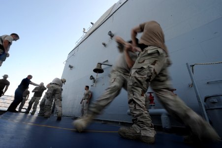 US Navy 090926-N-4154B-319 A combined team of U.S. Navy visit, board, search and seizure team members from the guided-missile cruiser USS Anzio (CG 68) and members of U.S. Coast Guard Maritime Safety and Security Team conduct w photo