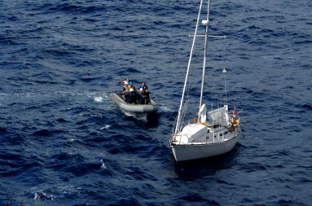 US Navy 090929-N-1688B-076 Sailors assigned to the guided-missile destroyer USS Cole (DDG 67) prepare to board an abandoned sailboat found drifting in the Atlantic Ocean