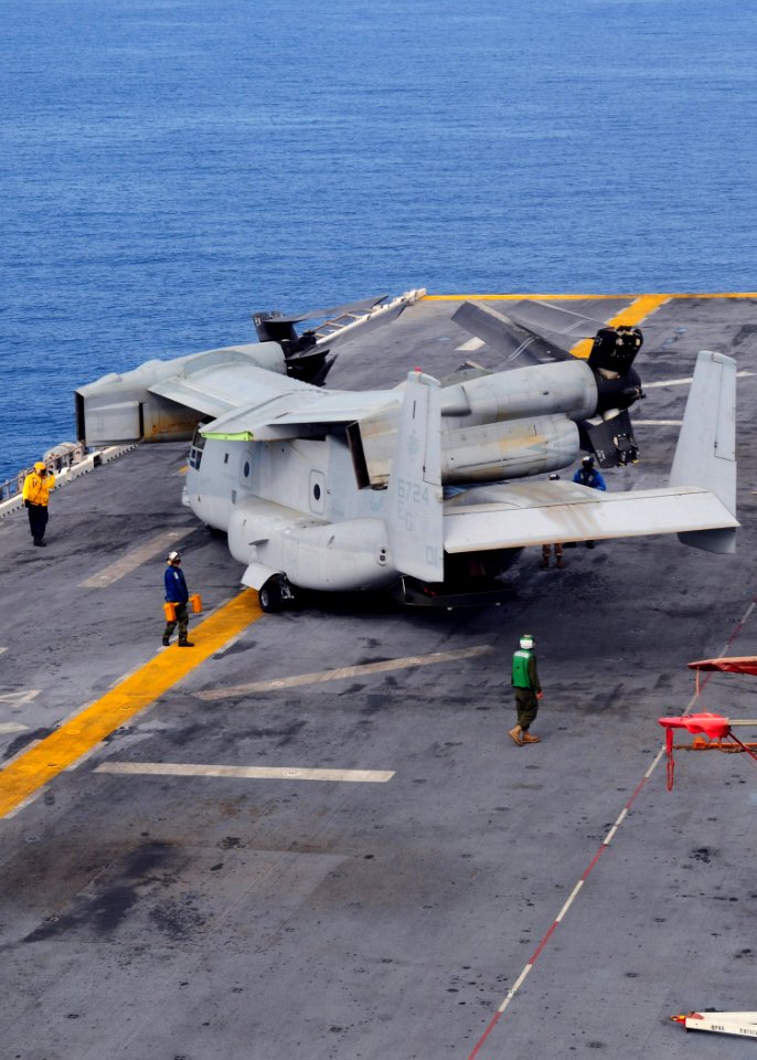 US Navy 091002-N-3165S-089 Sailors aboard the multi-purpose amphibious assault ship USS Bataan (LHD 5) and embarked Marines from the 22nd Marine Expeditionary Unit (22nd MEU) move an MV-22B Osprey