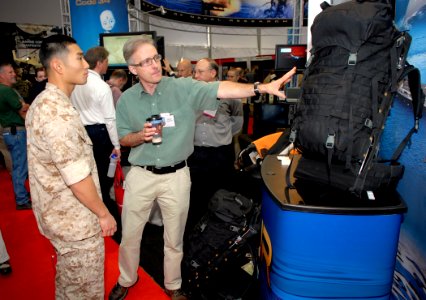 US Navy 090930-N-7676W-011 Marty Belcher, lead designer and developer of the Office of Naval Research-funded Lightning Pack, explains the benefits of the ergonomic and electricity generating backpac photo