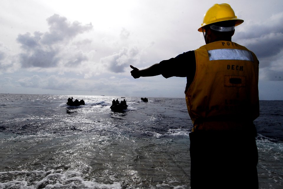 US Navy 090929-N-0807W-233 Seaman Bertram Taylor signals the combat rubber raid craft boats, manned by the 31st Marine Expeditionary Unit (MEU)