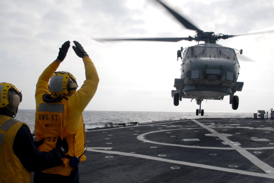 US Navy 090930-N-1688B-423 oatswain's Mate 2nd Class Brandon Carney, from Stratford, N.J., directs an SH-60 Sea Hawk helicopter assigned to the Vipers of Helicopter Anti-Submarine Squadron Light (HSL) 48