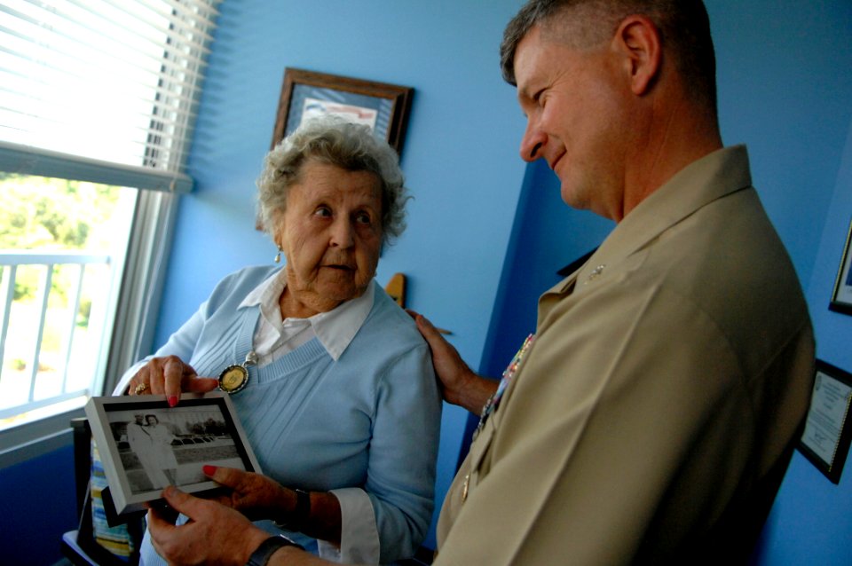 US Navy 090928-N-9818V-052 Master Chief Petty Officer of the Navy (MCPON) Rick West and Ima Black, widow of the Navy's first MCPON, Master Chief Gunner's Mate Del Black, look through old photos of Black during their visit