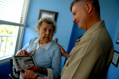 US Navy 090928-N-9818V-052 Master Chief Petty Officer of the Navy (MCPON) Rick West and Ima Black, widow of the Navy's first MCPON, Master Chief Gunner's Mate Del Black, look through old photos of Black during their visit