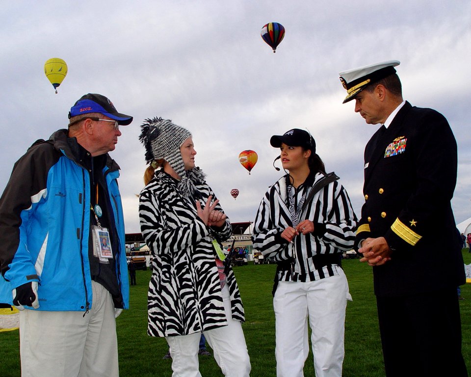 US Navy 091003-N-2888Q-003 Rear Adm. Paul Bushong, commander of Submarine Group 2, right, talks with flight controllers and balloon pilot, retired Brig. Gen. Mike Rice, left, at the Albuquerque International Balloon Fiesta