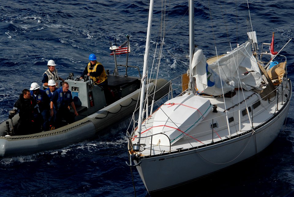 US Navy 090929-N-1688B-082 Sailors assigned to the guided-missile destroyer USS Cole (DDG 67) prepare to board an abandoned sailboat found drifting in the Atlantic Ocean
