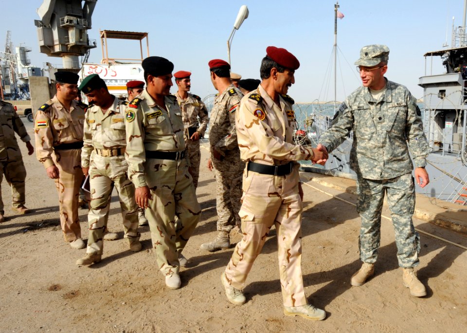 US Navy 090929-N-7088A-161 Cmdr. Chip Wrye, executive officer of Iraqi Training and Advisory Mission-Navy greets members of the Iraqi army and navy as they arrive