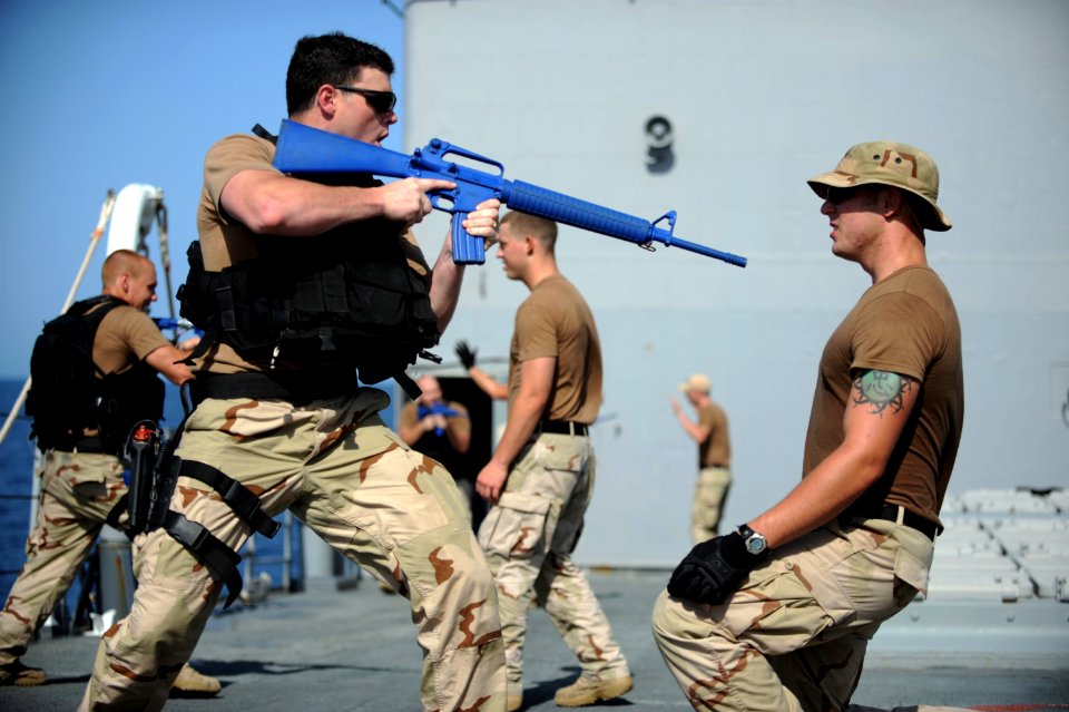 US Navy 090929-N-4154B-089 Lt.j.g. Kevin Snodgrass orders his partner to the deck during weapons retention training aboard the guided-missile cruiser USS Anzio (CG 68)