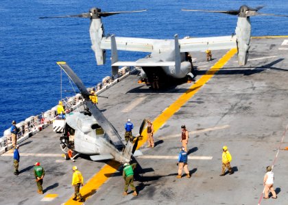 US Navy 091002-N-3165S-277 Sailors aboard the multi-purpose amphibious assault ship USS Bataan (LHD 5) and embarked Marines from the 22nd Marine Expeditionary Unit (22nd MEU), move an UH-1N Huey helicopter