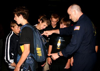 US Navy 091002-N-5366K-047 Cmdr. Gus Kaminski, a special warfare officer assigned to the U.S. Navy parachute demonstration team, the Leap Frogs, explains how a parachute functions to students at Green Hope High School after the photo