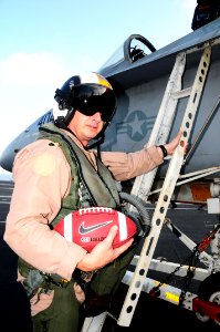 US Navy 090929-N-9760Z-001 Cmdr. Max McCoy, executive officer of Strike Fighter Squadron (VFA) 86 takes the Army Navy game ball on a mission aboard the aircraft carrier USS Nimitz (CVN 68)
