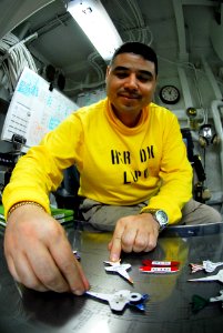 US Navy 090930-N-2918M-024 Chief Aviation Boatswains Mate (Handling) Jorge Sanders adjusts planes on the Ouija Board in hangar bay control aboard the aircraft carrier USS Nimitz (CVN 68)
