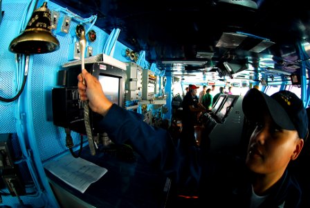 US Navy 090929-N-2918M-057 Boatswains Mate 3rd Class Maraalyssa Maneru rings the bell on the bridge to indicate the time-of-day aboard the aircraft carrier USS Nimitz (CVN 68)