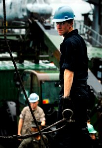 US Navy 091003-N-0807W-133 Seaman Craig R. Murphy monitors a steady line from a shore crane to cargo equipment during a Marine equipment offload aboard the amphibious dock landing ship USS Harpers Ferry (LSD 49