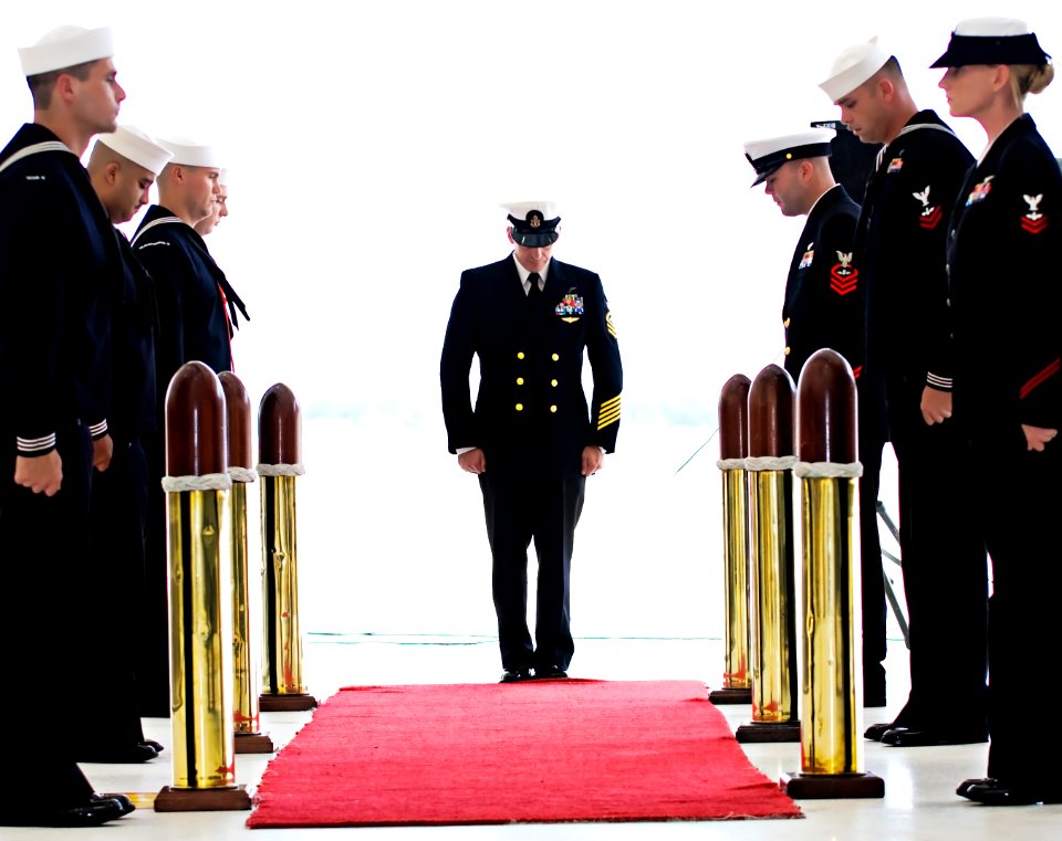 US Navy 091002-N-0871W-199 Chief Aviation Ordnancemen James Beraducci and the side boys at his retirement ceremony bow for a prayer
