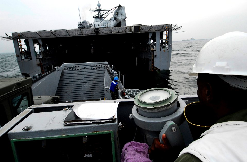 US Navy 091005-N-0807W-997 Chief Boatswain's Mate Vernuan J. Hinson gives orders to the bridge as Landing Craft Utility 1631 approaches the amphibious dock landing ship USS Tortuga (LSD 46)